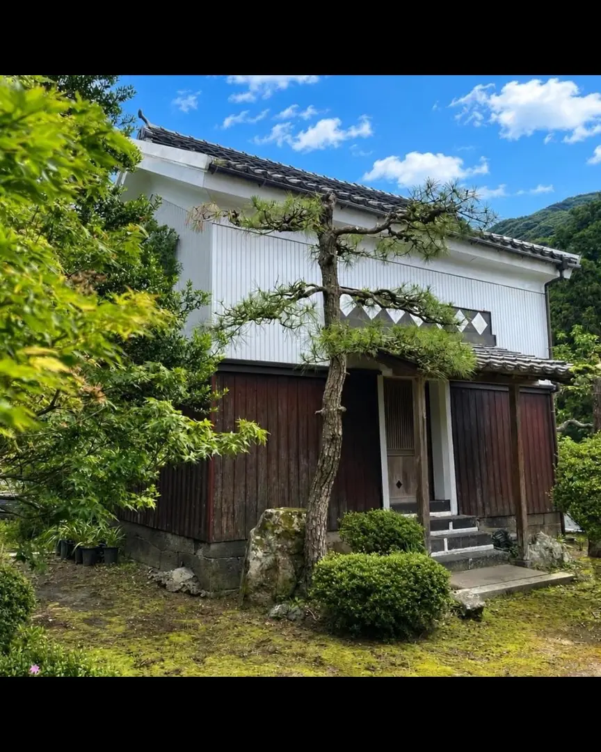 100-year-old farmhouse with farmland and a storehouse