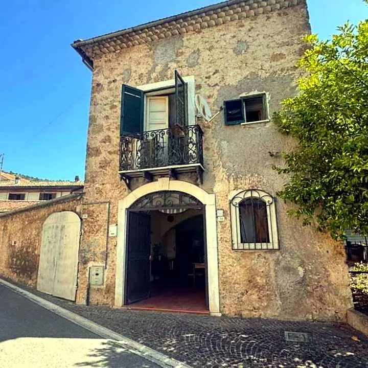 Rustic stone house with courtyard, balcony and several outbuildings