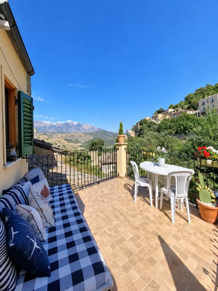 Stone house with a terrace and mountain views