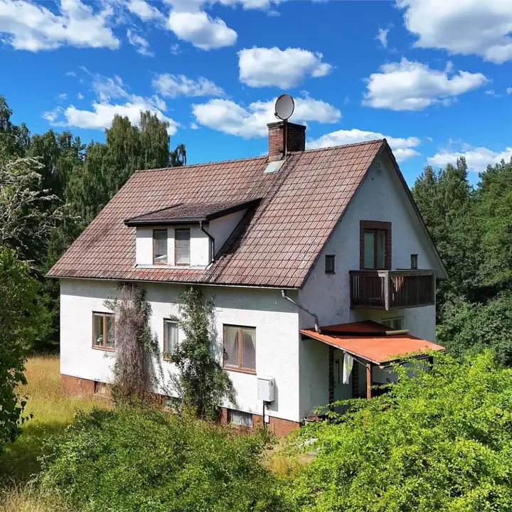 Family house on a green riverside plot