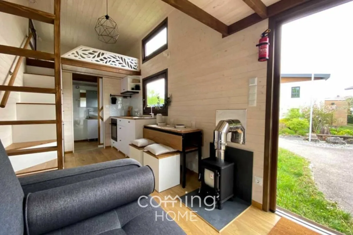 Wooden tiny house with two lofts and a wood stove, ready to move