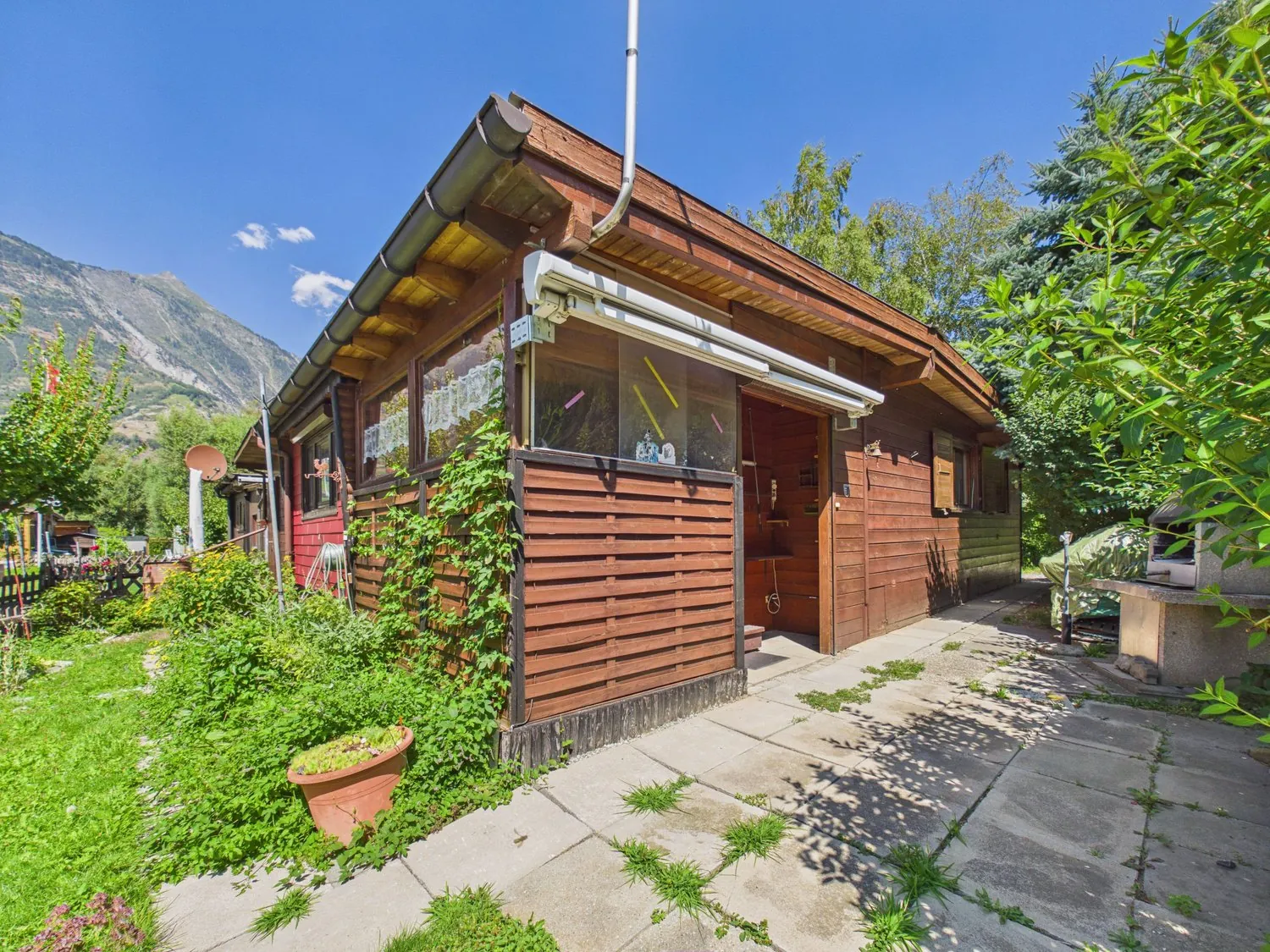 Winter-proof wooden chalet by a stream in the Valais Alps