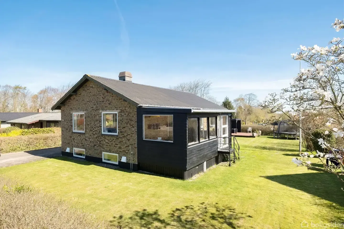 Black-timber villa with a covered deck, walk to town