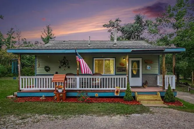 Lake-country home with a wood stove, deck and pool near Big Wolf Lake